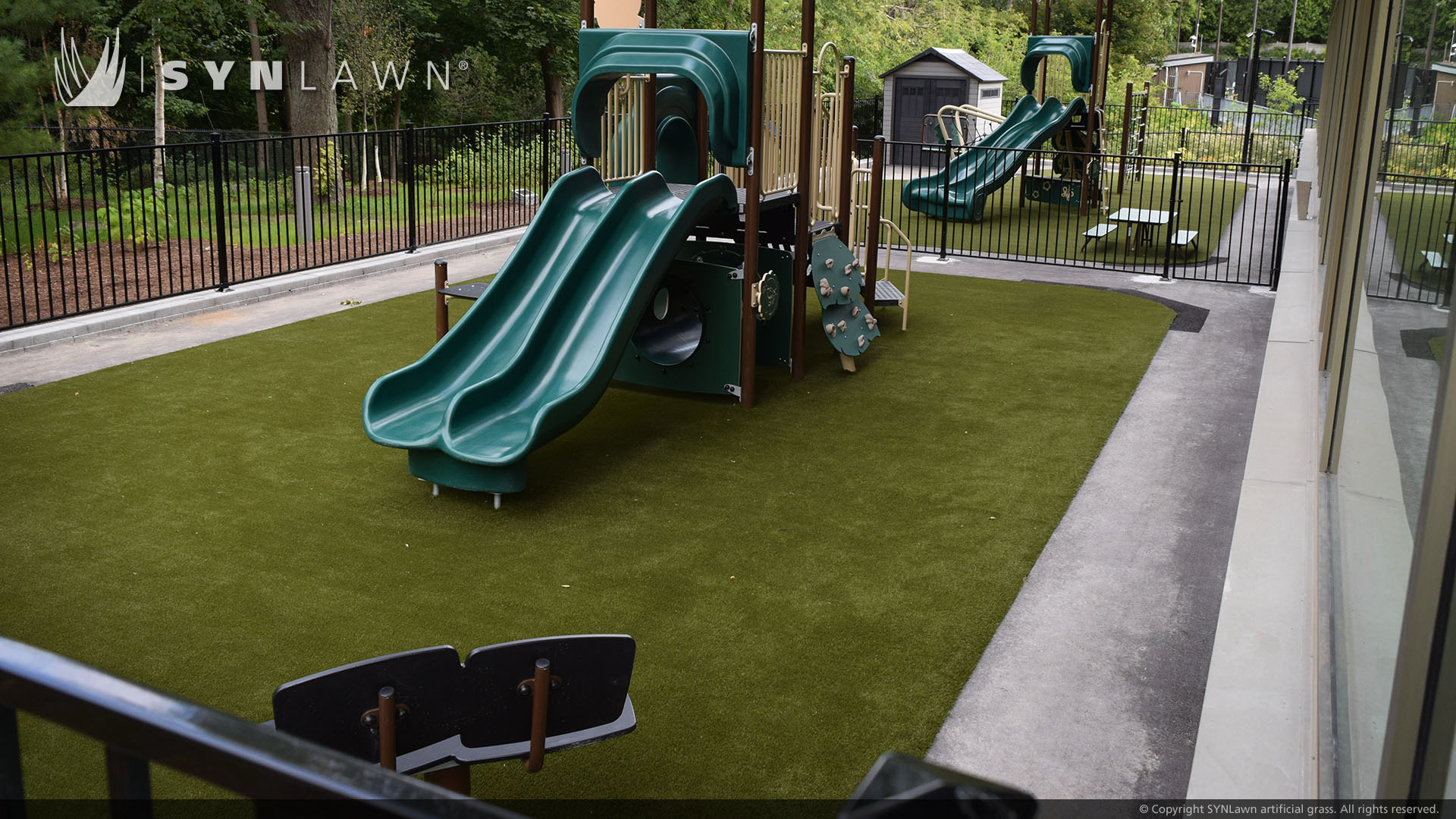 Green slide installed on SYNLawn artificial playground grass