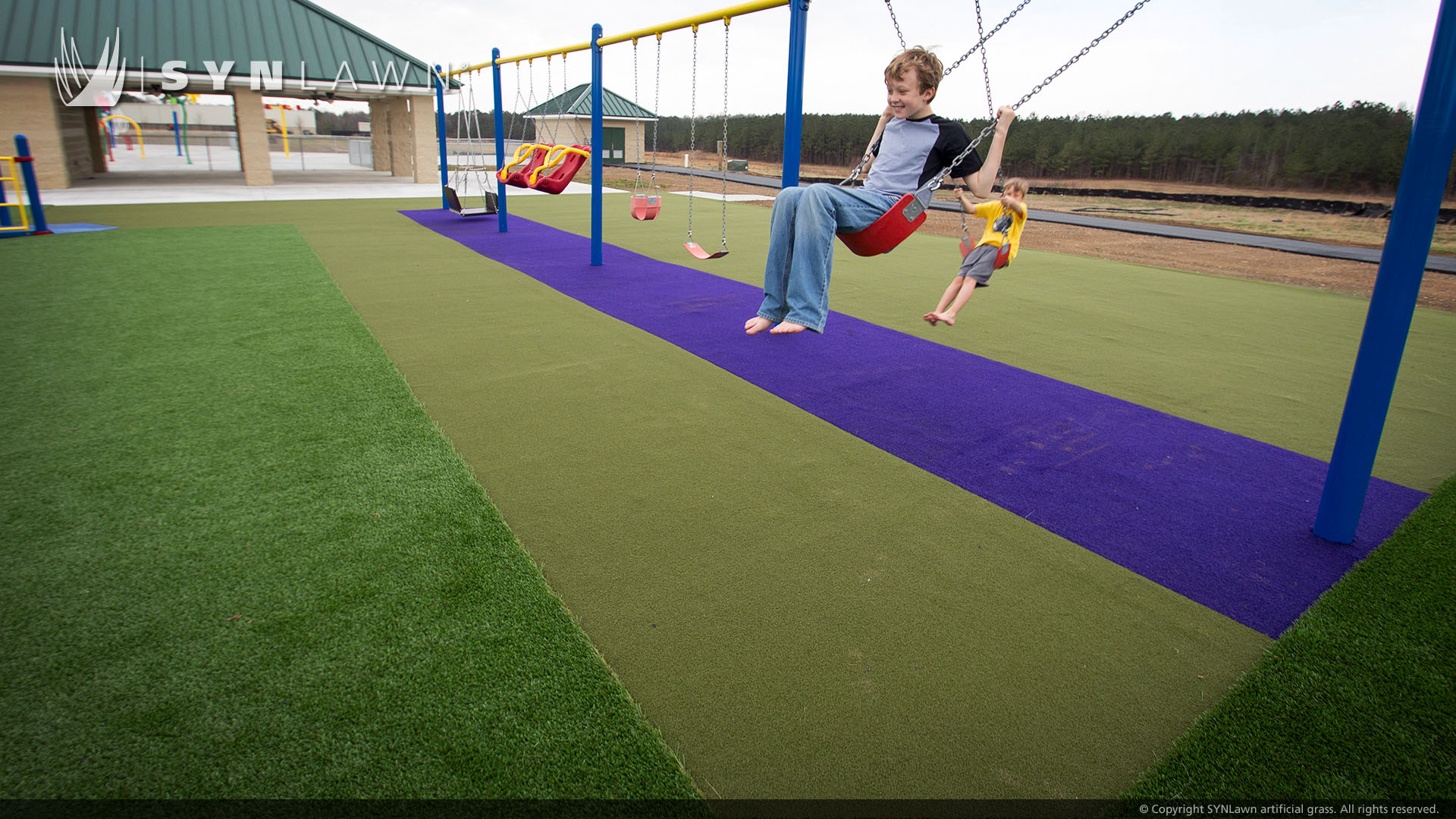 Swingset installed on artificial playground grass