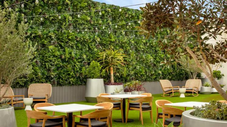 Hotel common area with artificial living wall and artificial grass